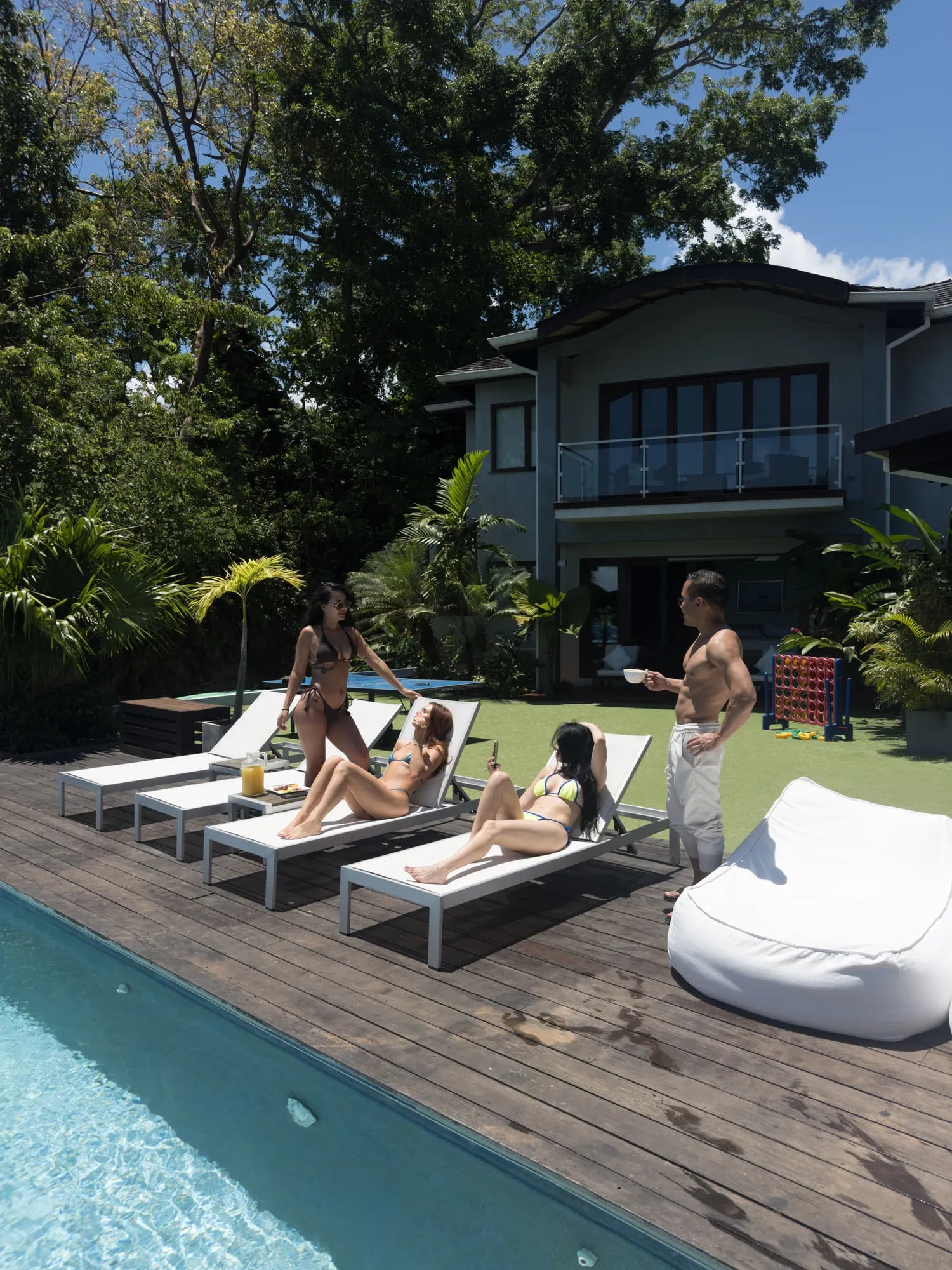 Guests lounging by the pool of a private villa
