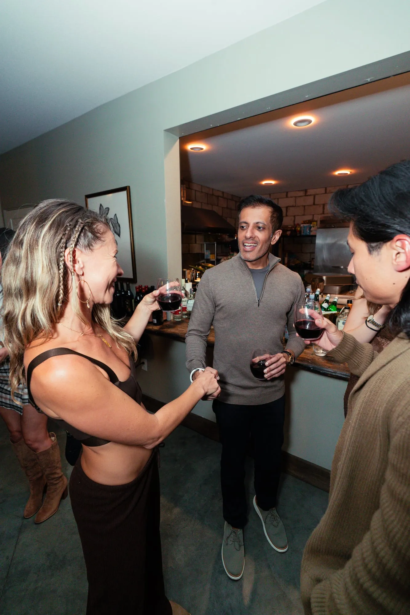 Guests greeting each other over glasses of wine